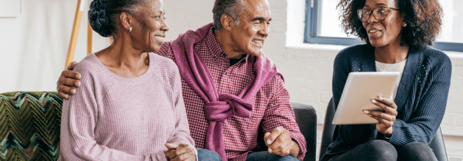 Two people, a couple, getting information from a health insurance representative.