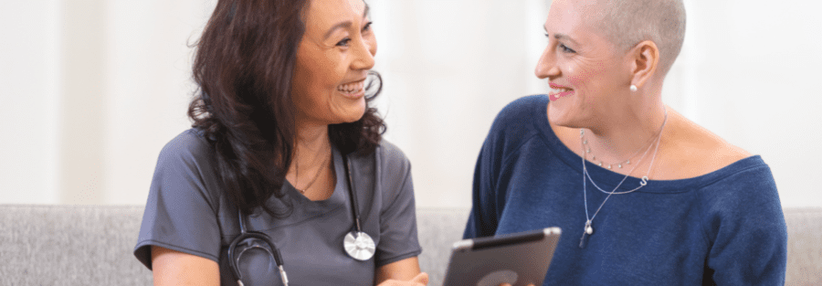 A doctor with a woman in the woman's home.